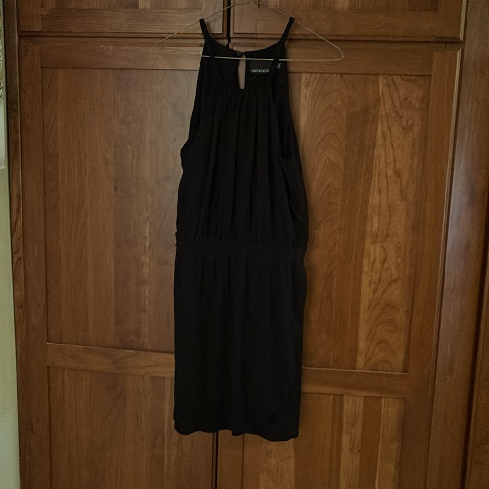 Women’s short black dress.  Elastic waist key hole with button in back.  Size M